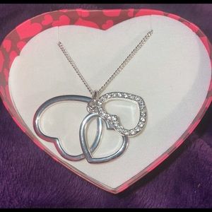 New never worn Avon 3 heart silver necklace. The back of the box is damaged